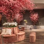 Elegant indoor lounge featuring cherry blossom decorations and plush seating for a sophisticated ambiance. — 3 Small Home Imp