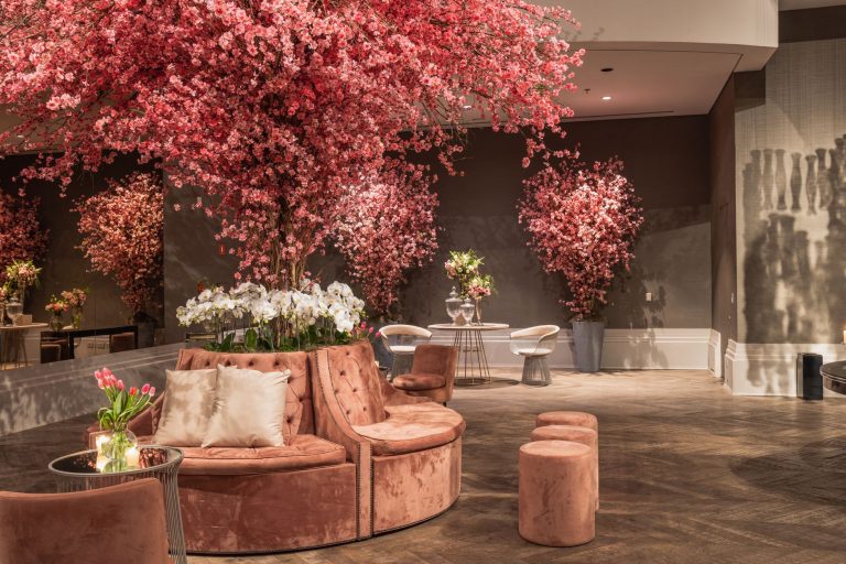 Elegant indoor lounge featuring cherry blossom decorations and plush seating for a sophisticated ambiance. — 3 Small Home Imp