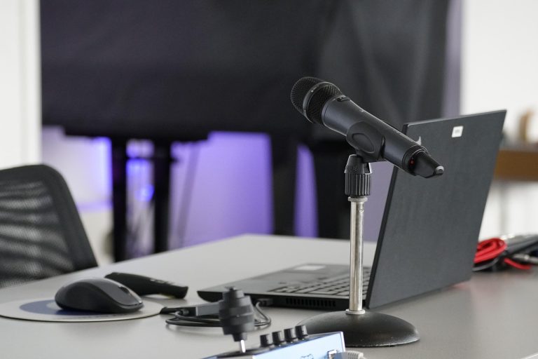 Laptop, conference table, mouse — "Stars By The Harbour: A Glimpse Into Its Premier Housing Features"